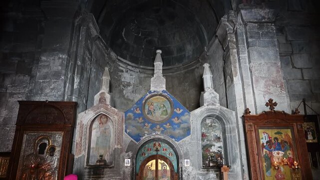 Ancient altar interior of Gergeti Trinity Church in Kazbegi, Georgia. Medieval orthodox frescoes and icons on stone walls, spiritual heritage, religious tourism and historical landmark concept
