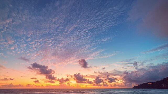 Captivating time lapse of a serene beach sunset with vibrant colors painting the sky and ocean horizon. The interplay of light, clouds, and waves creates a tranquil yet visually striking atmosphere