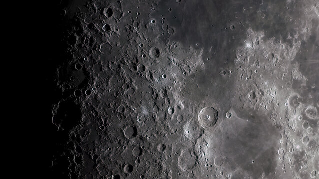 A high-magnification photo of the moon with craters through a telescope