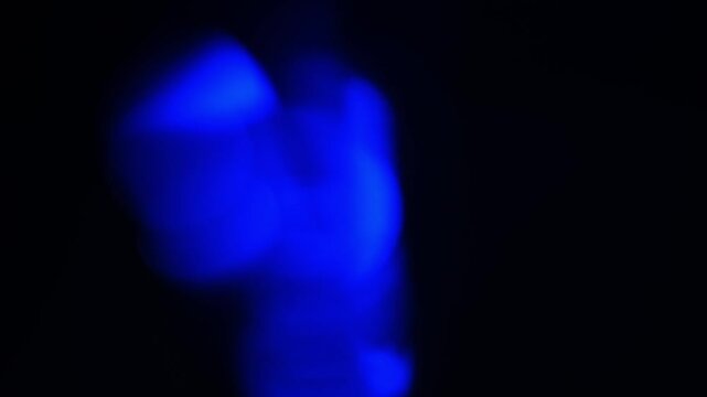 Colorful light reflections create interesting patterns in dark space during evening hours