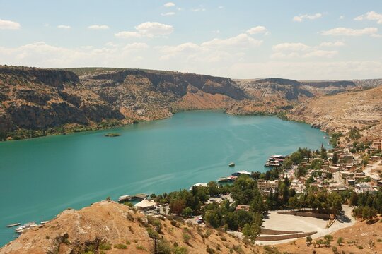 Aerial view of Halfeti with scenic hillside on Euphrates River, Turkey. June, 2022. Famous sunken village of Halfeti, featuring the turquoise waters of the Euphrates river surrounded by rugged hills.