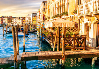romantic view of a canal in Venice with boats and blue water and beautiful vintage buildings around the cityscape © Yaroslav