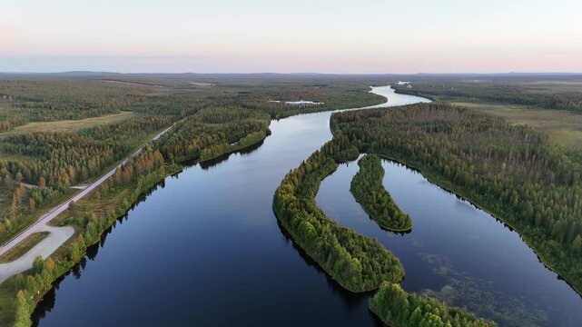 Aerial drone over Kitinen River and green taiga forest in late August