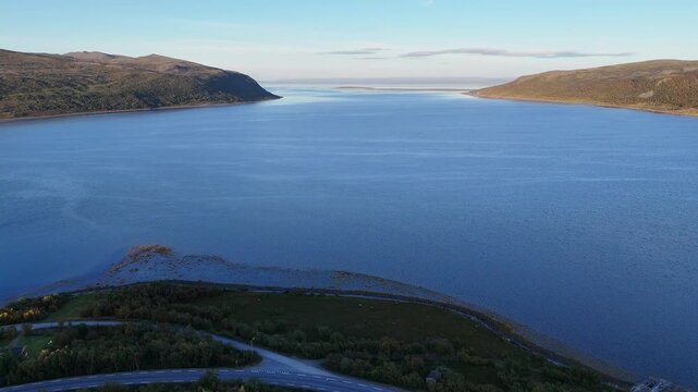 Aerial drone flying away from Olderfjord shore Norway