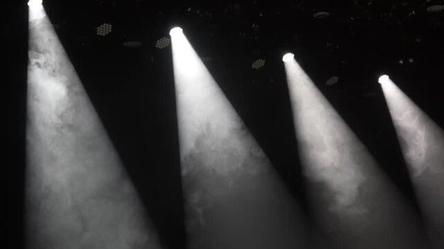 Cinematic Multiple Bright Stage Spotlights Cutting Through Thick Smoke in the Dark, Horizontal