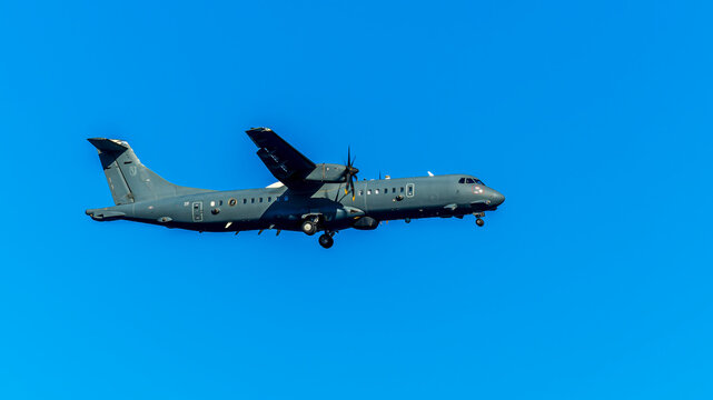 Military exploration aircraft in flight on blue sky background. Poseidon jet of european air force in flight. Aviation of european army.