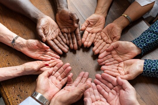 Diverse hands forming unity circle.