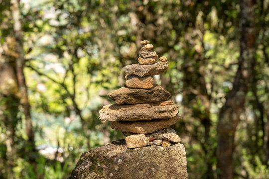 Paro Bhutan, rock cairn beside trail in forest