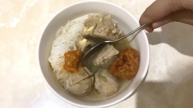 Bakso Dish Being Served with Spoon - Top View