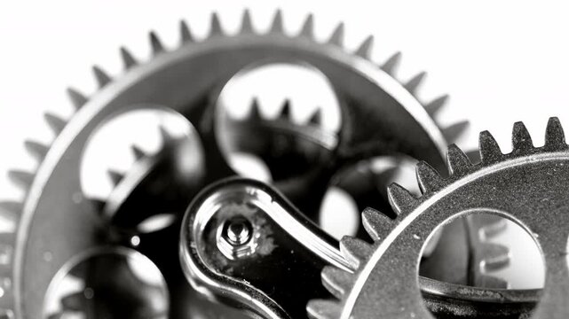 High-quality macro footage of interlocking metal gears in motion. Perfect for industrial, engineering, teamwork, and mechanical concept videos.