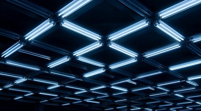 A low angle view of a ceiling grid of fluorescent lights creating pattern