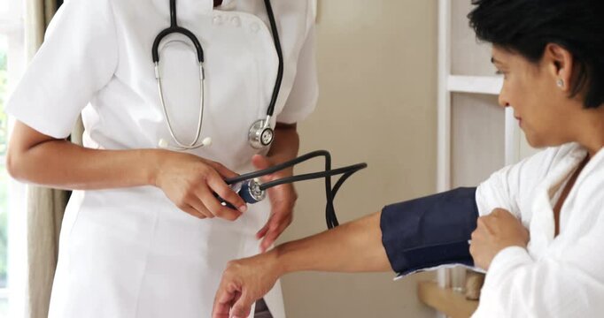 Doctor measuring blood pressure of patient using sphygmomanometer, healthcare checkup and hypertension concept.