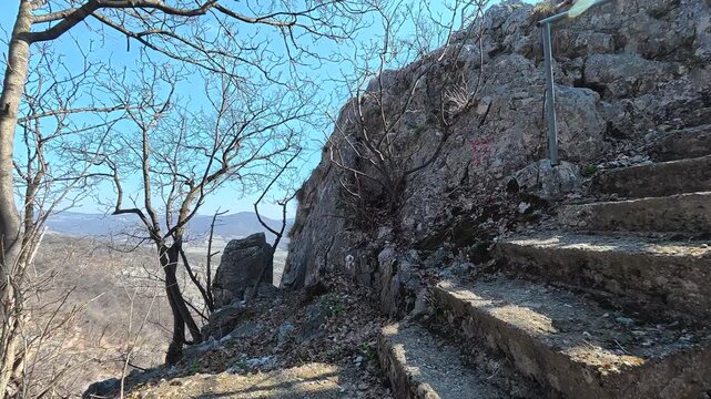 Stone steps climb rocky slope under clear blue sky. Lazarev (Lazar's) Canyon. Balkans, Serbia.