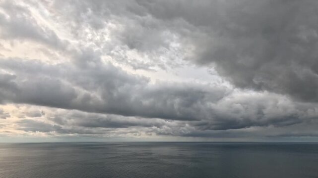 Clouds ocean storm dark dramatic clouds moving across the sky over the horizon of the vast sea
