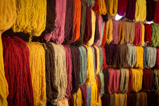 Colorful skeins of naturally dyed alpaca wool at Awana Kancha, Peru