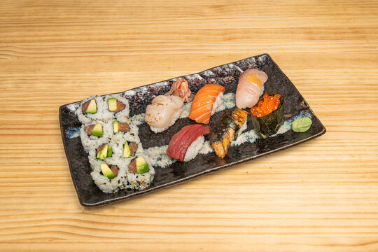 The contrast between the blood red of the akami (lean tuna) nigiri and the pale green of the freshly grated wasabi peeking out