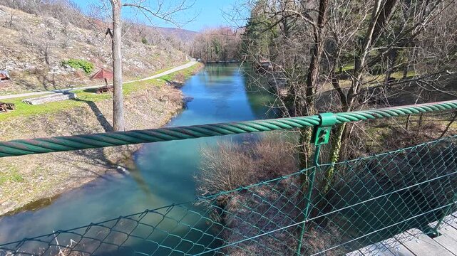 Wooden walkway stretches over calm, clear river. Lazarev (Lazar's) Canyon. Balkans, Serbia.
