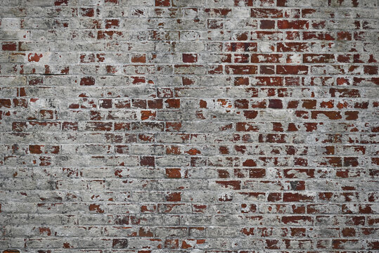 Background of paint pealing from a whitewashed brick wall 