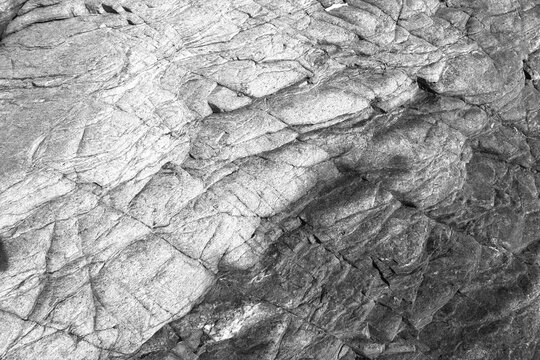 Dark grainy stone texture background with fine grit