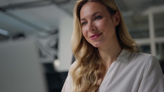 Happy adult Caucasian business woman typing laptop software in company office smiling cheerful businesswoman chatting online communicating work smile middle-aged female employer working in agency