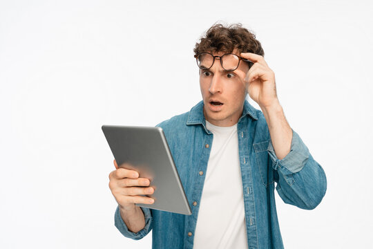 Tablet, confused and studio with shocked man portrait. Internet software glitch, planning or troubleshooting, confused with coding mistake, system solution or test on white background