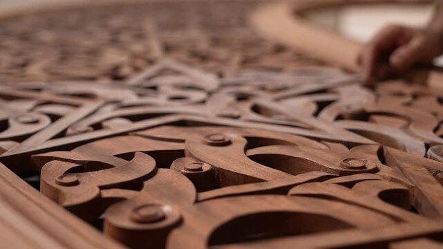 Close-up footage of a skilled artisan carving intricate patterns on wood. Showcasing traditional craftsmanship, fine details, and natural textures in a mesmerizing handmade process.