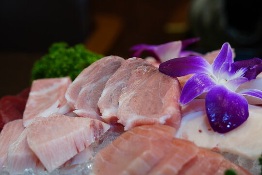 Fresh premium maguro sashimi set decorated with edible flowers in a Japanese restaurant
