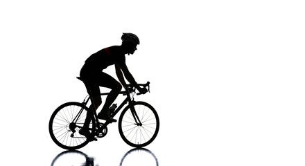 Obraz premium Silhouette of a cyclist in motion on a road bike, isolated on white background