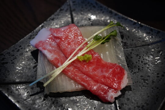 Close up of marbled fatty tuna sashimi slice (Otoro) served in a luxury restaurant