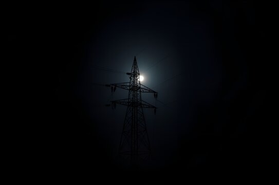 Power Lines Silhouetted Against a Bright Moon