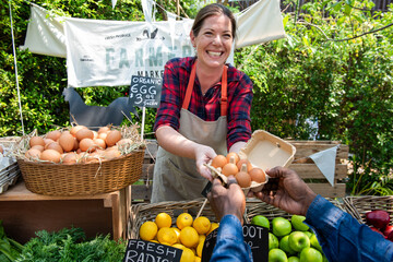 Smiling vendor selling fresh produce