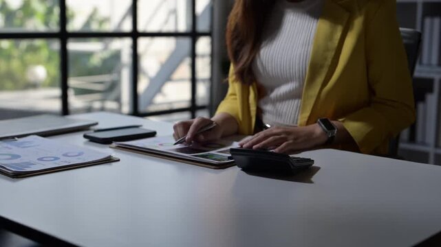 Successful businesswoman celebrating achievement at her office desk
