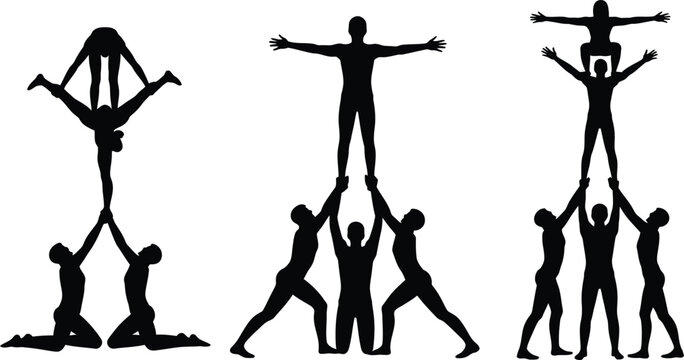 Black silhouette acrobats form impressive human tower formations.