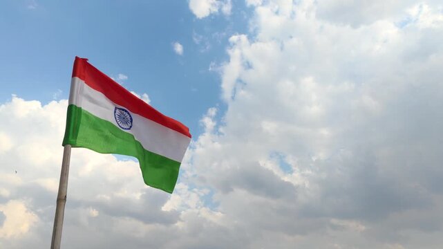 Waving indian national flag against cloudy sky independence, horizontal 4k video footage.