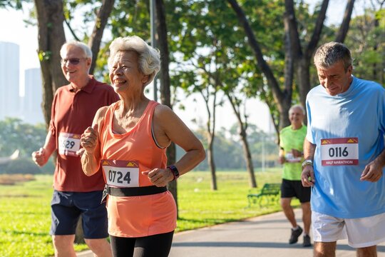 Elderly group running marathon outdoors.