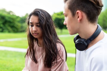 Fototapeta premium Teenagers conversing in park photo