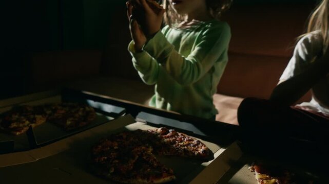 Two pizza boxes on a table during movie night