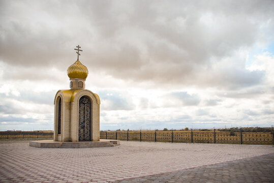 Small Orthodox chapel with a golden dome in Karaganda. Ideal for travel guides, religious articles, or regional news about Kazakhstan. This architectural photo captures a peaceful spiritual landmark