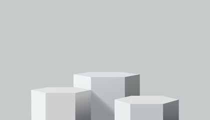 Three Hexagonal Podium Stands of Varying Heights on a Neutral Gray Background with Subtle Shading and Depth © Jen