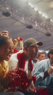 Vertical Screen. Sport Stadium Fans Celebrate a Soccer Championship as a Diverse Crowd Cheers, Waves Red and White Scarves, and Smiles in Close-up During a Major International League Match.