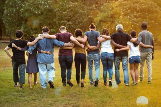 Group of friends huddle in rear view together