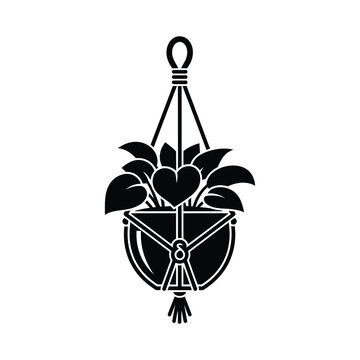 Black and white silhouette of a hanging plant in a macrame hanger