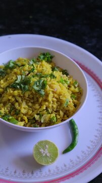 Traditional Indian Poha Breakfast with Lemon and Chili