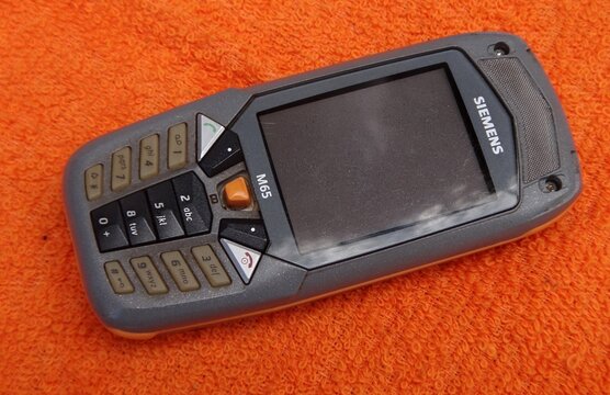 Siemens M65 rugged vintage mobile phone on orange surface