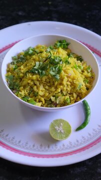 Fresh Indian Poha served in a bowl with lemon and green chili - 4K Stock Footage