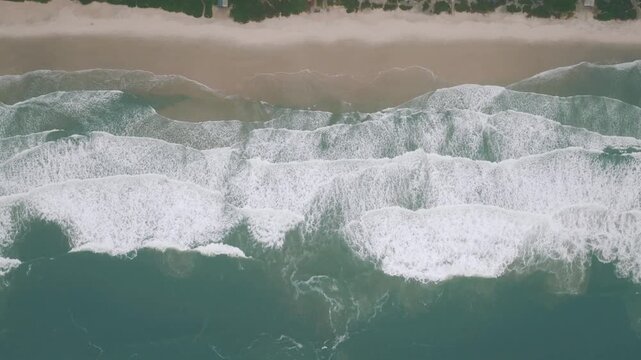 Top down drone view of waves at Ingleses Beach, Brazil