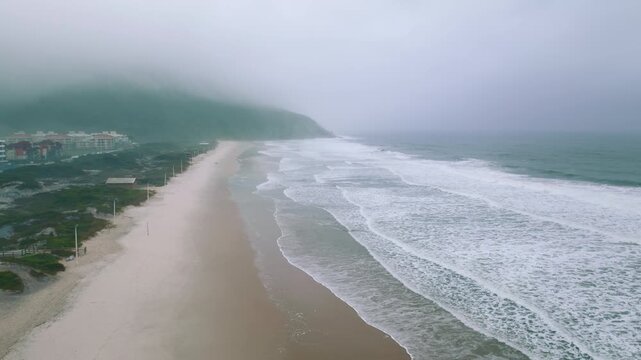 Foggy aerial along Ingleses Beach coastline in Florianopolis