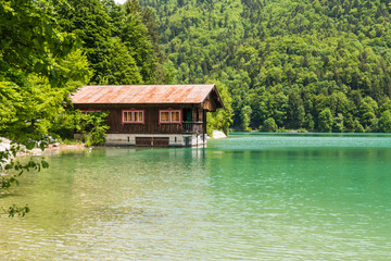 Obraz premium Traditional wooden boat house on the turquoise shore of Lake Walchensee in the Bavarian Alps 