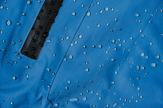 Water droplets on blue waterproof material. Water repellent fabric.