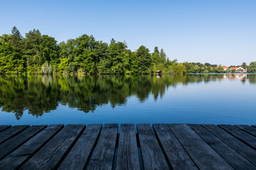 Obraz premium Wooden pier overlooking the calm water of Wesslinger See lake in Bavaria, Germany